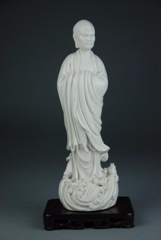An Antique blanc-de-chine figure of Damo: A glazed, pearl white, realistic sculpture of figure Damo. Moustache and beard beneath the bald head .Height 11 in,