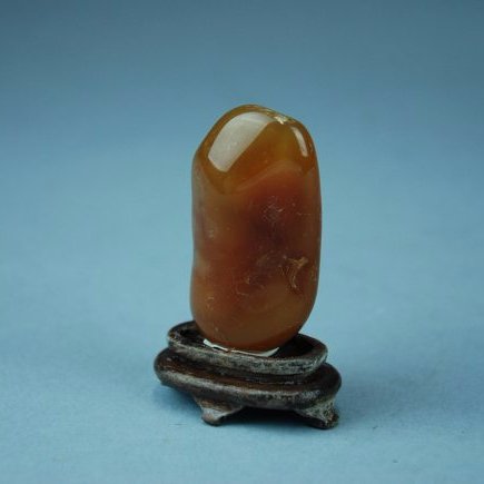 A Tianhuang soapstone: This piece is very smooth and semi-transparent. The color of this stone is a lovely shade of amber red with hues of yellow. Height 2 in