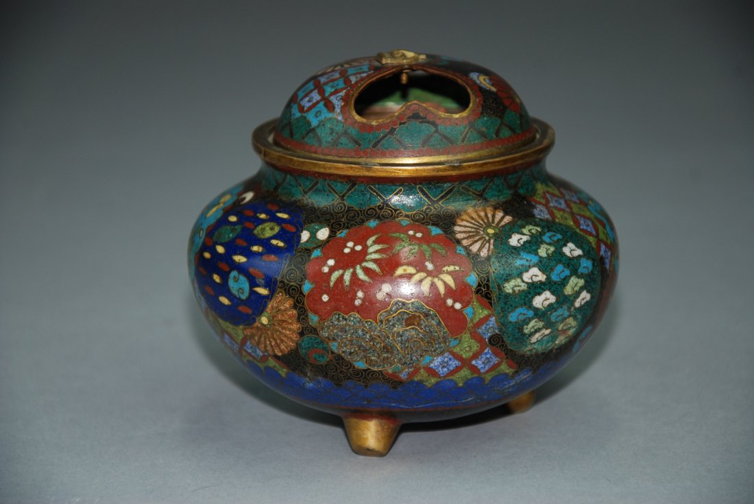 An Antique Cloisonne enamel burner and cover: This piece is covered with flowers and butterfly that are multi colored. This burner and cover is made of gilt-bronze. Height 4 in, Diameter 4.5 in
