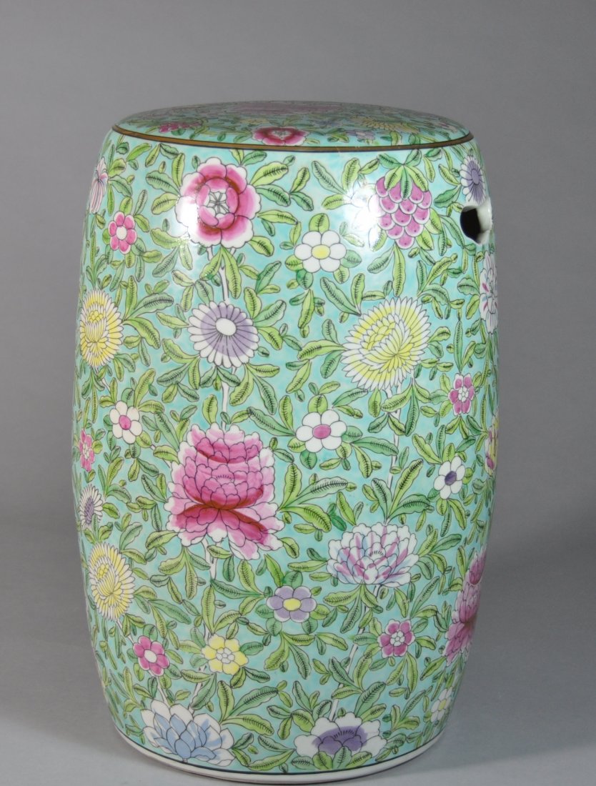A 19th century famille rose porcelain garden seat: This piece is surrounded in a vivid sea-green glaze with various and decorative floral icons. Height 45.5 cm, Diameter 26 cm