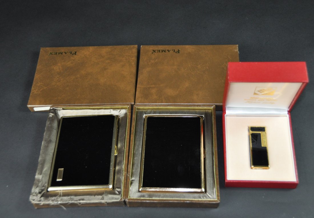 A collection of three vintage lighters and cigarette (1 of 5)