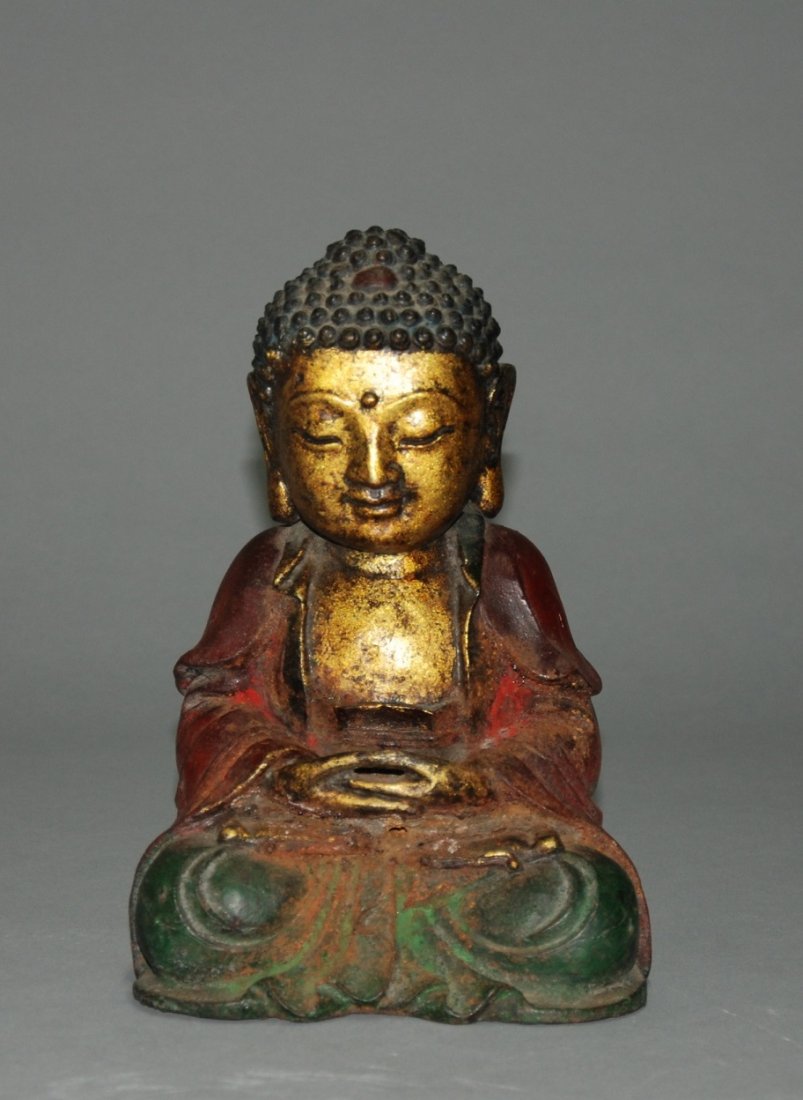 A Ming dynasty cast bronze figure of a Buddha: This piece is a gilt bronze and painted piece. This Buddha is seen in a meditation stance. Height 23cm, Width 15cm.