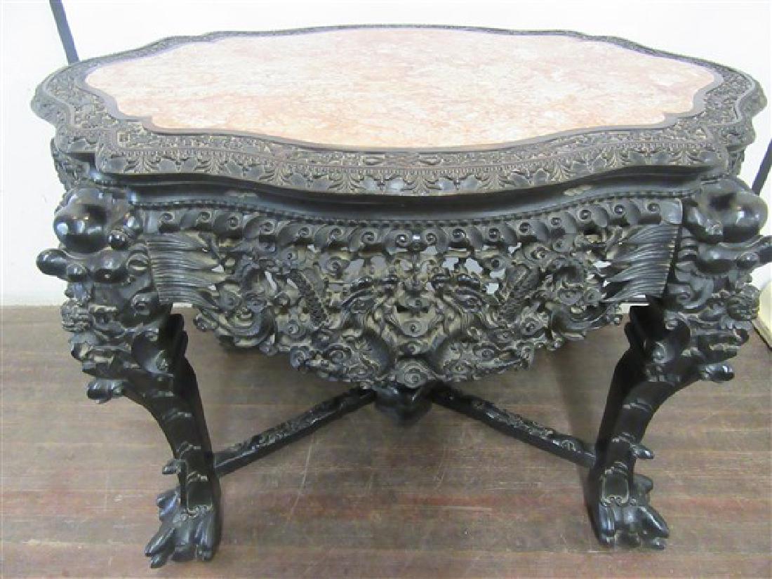 19th Century Chinese Carved Hardwood Center Hall Table: A fine 19th century Chinese carved hardwood table. Highly detailed carvings with carved foo dogs, Chinese figures and cross stretcher come together at base with a sea serpent carved wood finial (remov