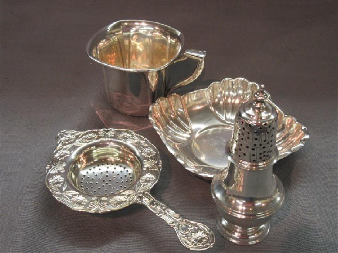 Sterling Silver Table Wares Lot: A compiled grouping of sterling silver table wares including salt shaker, tea strainer, cup and small bowl. t.w.: 9.7 avg. oz.