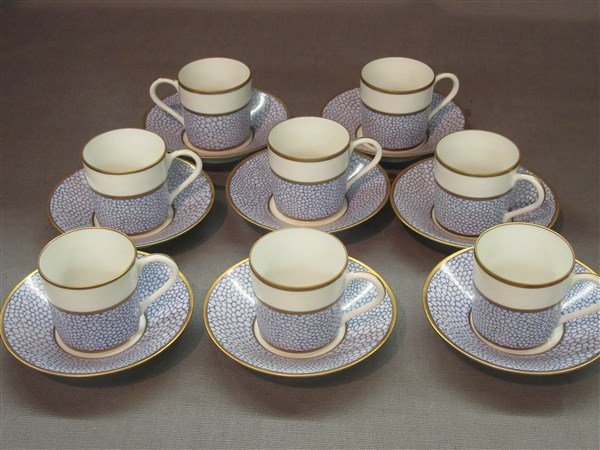 Manuel Canovas for Puiforcat Limoges Cups And Saucers: A set of eight (8) Manuel Canovas for Puiforcat Galuchat Limoges porcelain cups and saucers. Made in France. A fine blue and white pebble design with gold trim. Dimensions: 3"h X 4 1/2"d