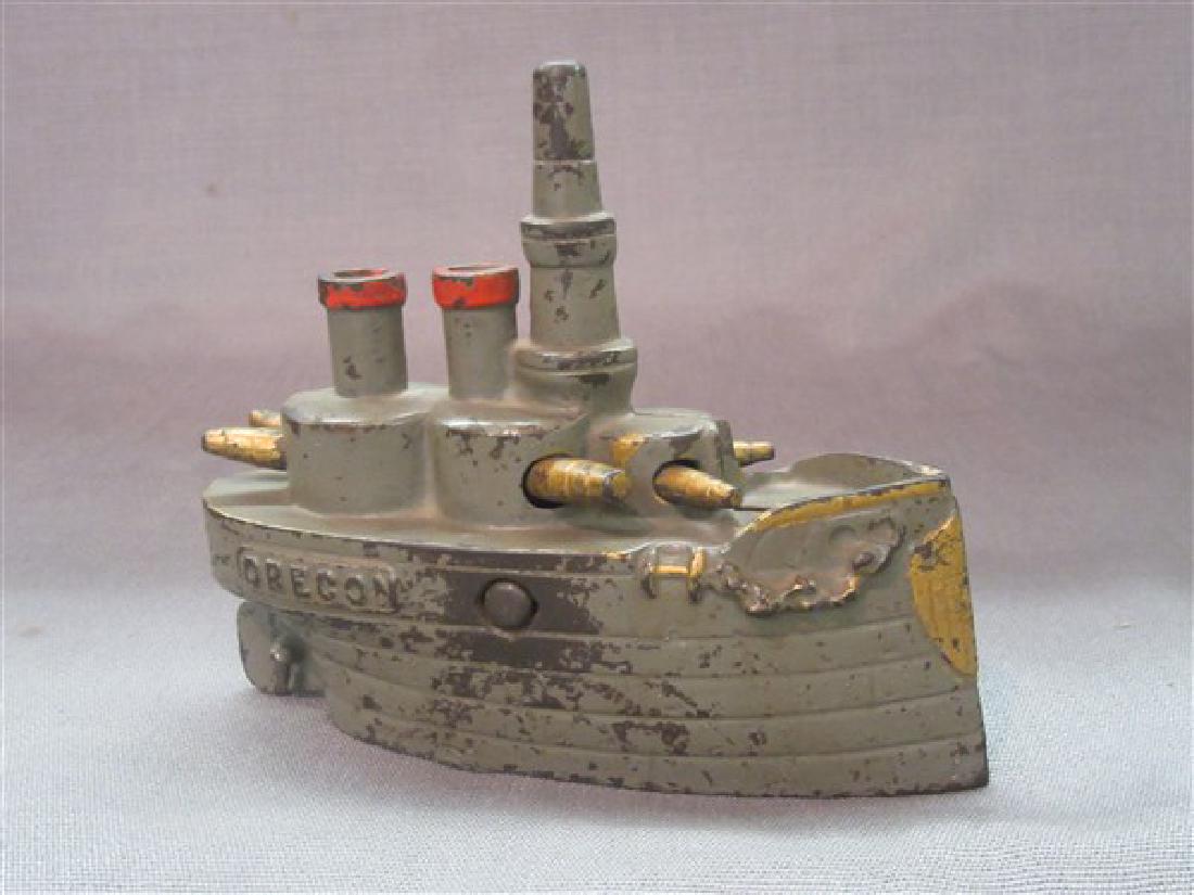 Battleship Oregon Cast Iron Still Bank: Battleship "Oregon" Still Bank. This bank measures 6" long and 5" tall. Made from cast iron. Most of green paint remains with gold trim. Flannery's Estate Services 26 Recreation Park Rd. Pine Bush, NY