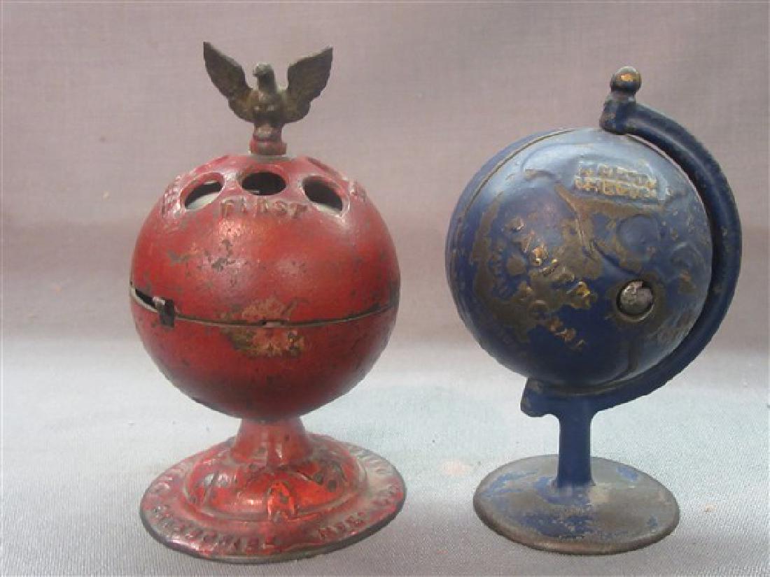 Pair of Cast Iron Globe Banks: Two "Globe" still banks. Blue paint Globe on Arc bank made by Grey Iron Manufacturing in the early 1900's. This cast iron still bank measures 5-1/2" tall. Red paint Globe Bank with eagle on top made b