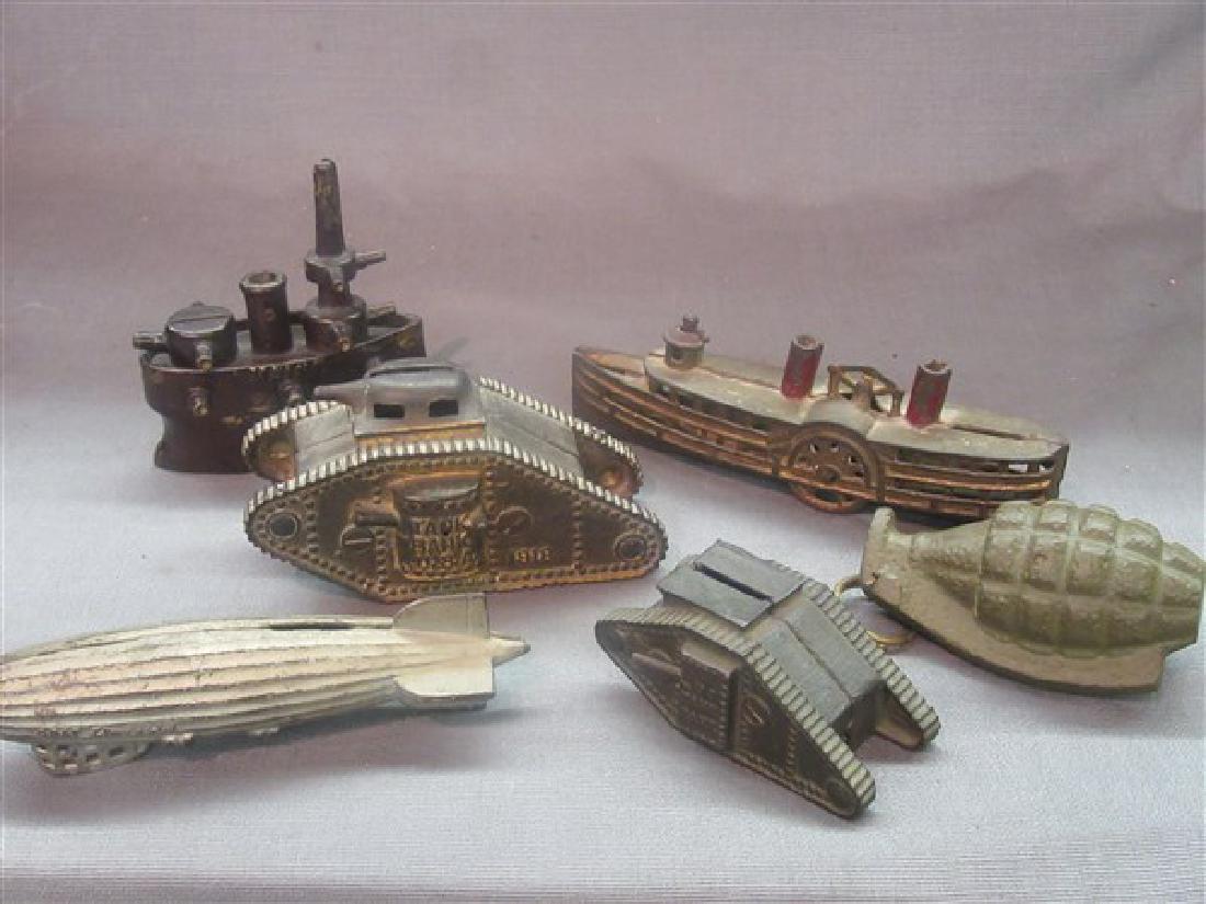 Six (6) Cast Iron Still Banks: Six (6) cast iron still banks including Graf Zeppelin, 1918 Tank bank, steamship, grenade, fighter ship, U.S. Maine and tank bank.