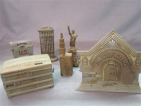 Six (6) Cast Iron Antique Still Banks: Six (6) cast iron antiques still banks including Flat Iron building Dime bank, Recording bank, Statue Of Liberty, US Mail and Skyscraper building. Dimensions: 6 1/2" tallest height