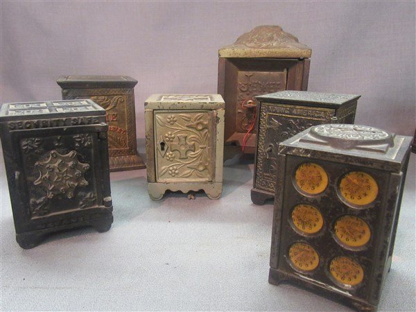 Six (6) Cast Iron Antique Still Banks: Six (6) cast iron antique still banks in floor safe form including The Jewel Safe, Young America Safe, Security Safe Deposit, Washington bank with world clocks, Dime bank 221 North 12th St. and Steven