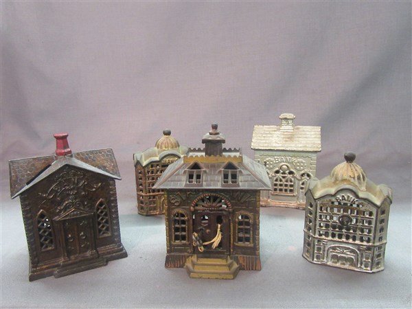 Five (5) Bank Building Antique Still Banks: Five (5) Bank building figural still banks as seen in photograph preview. Dimensions: 6" X 4" (tallest)