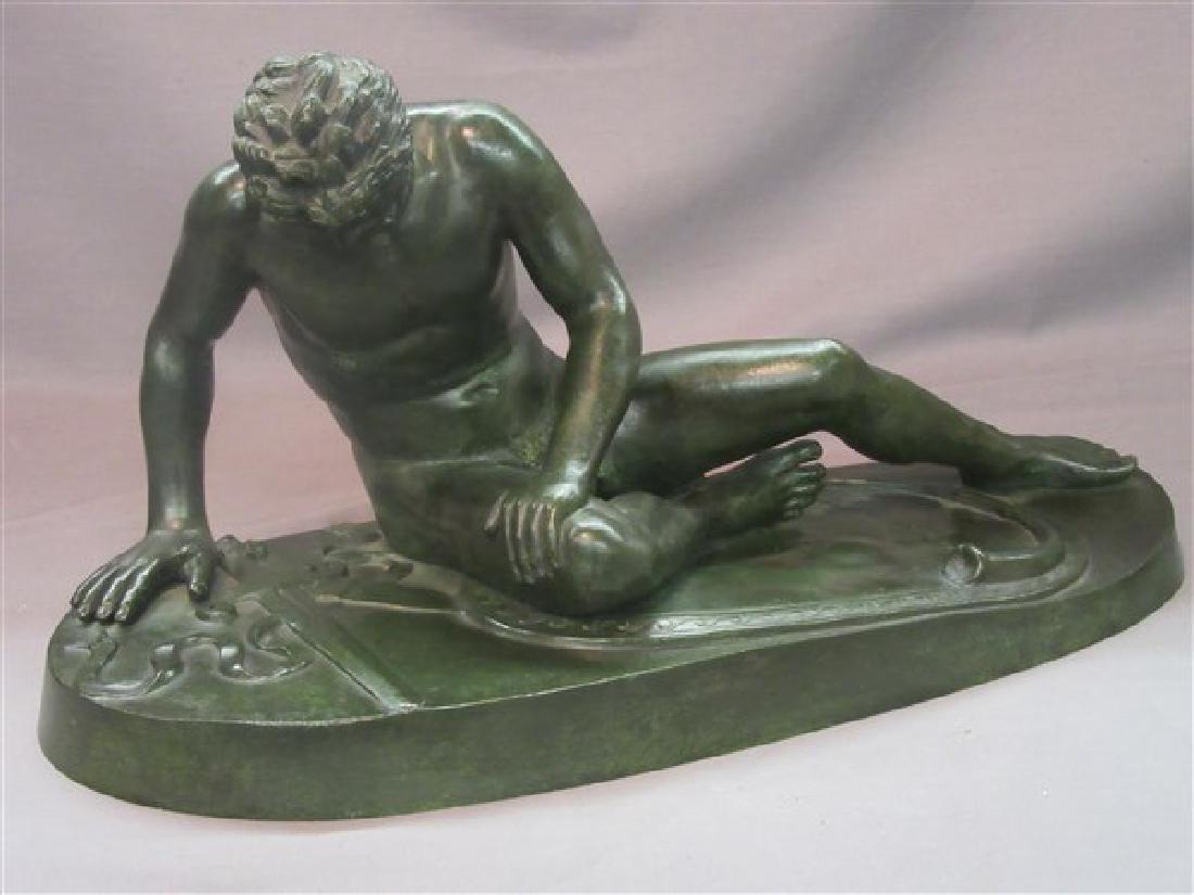 Bronze Male Statue: A defeated nude bronze man with sword placed lying down at side. Contemporary.Dimensions: 10"h X 18"l