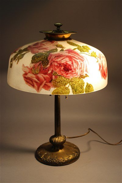 Pittsburgh Reverse Painted Roses Table Lamp: A fine Pittsburgh reverse painted table lamp with reverse painted roses and chipped ice style shade. Signed at base. Dimensions: 18"h X 16"d