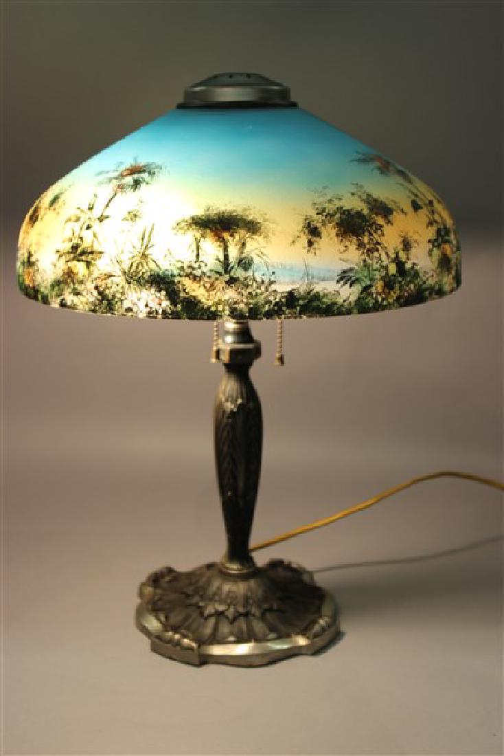 Pittsburgh Tropical Island Glass Table Lamp: A Pittsburgh table lamp with reverse painted tropical island scene shade. Base is steel color, Art Deco design. Dimensions: 18"h X 13 1/2"d
