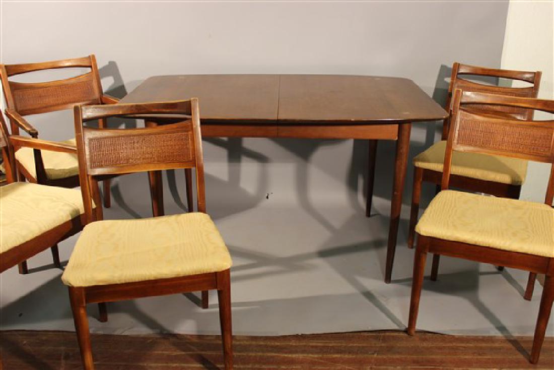 Mid Century Modern Dining Room Table And Chairs: Mid century modern design dining room table and chairs. Table having inlaid steel "X" pattern. Five chairs total. Dimensions: Table 29 3/4" X 52" X 36" Chairs 33 3/4" X 22 1/2" X 18 3/4" and 33" X 19