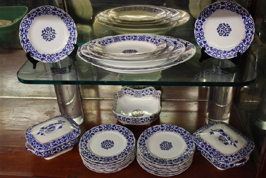 Blue And Gold Royal Vienna Porcelain Dinner Service: Twenty-Three (23) piece dinner service by Royal Vienna, Austria consisting of Four (4) graduated platters, Two (2) covered vegetables, One (1) open serving bowl and sixteen 8 1/2" plates.