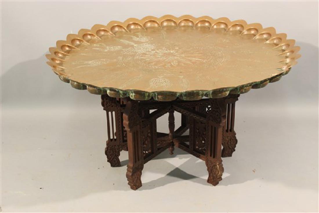 Antique Moroccan Brass Folding Tray Table: An antique Moroccan brass folding tray table. Note large diameter 37" Dimensions: 19 1/2"h X 37 1/2" diameter