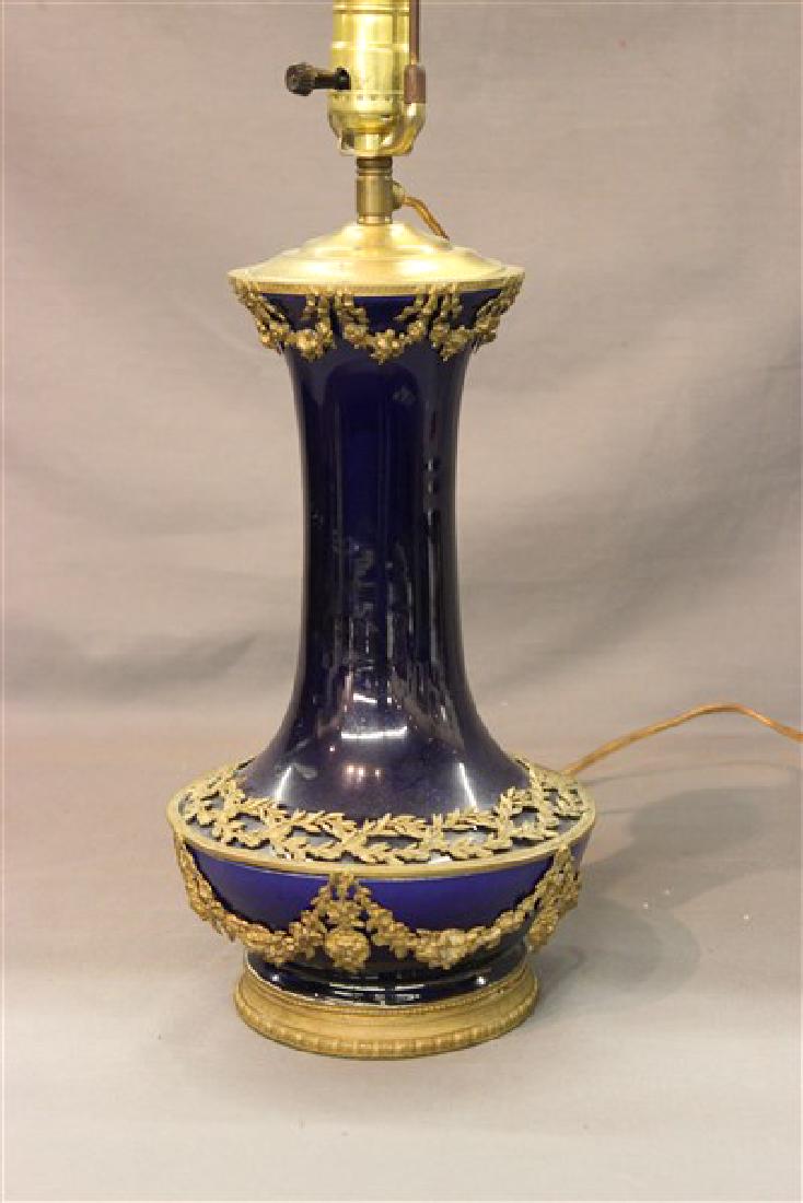 French Cobalt Blue Porcelain Ormolu Table Lamp: A French cobalt blue porcelain ormolu mounted table lamp. Originally a vase turned into a lamp. Note this piece is not drilled Dimensions: 12" X 7 1/2" (Vase) and 28" X 7 1/2" overall