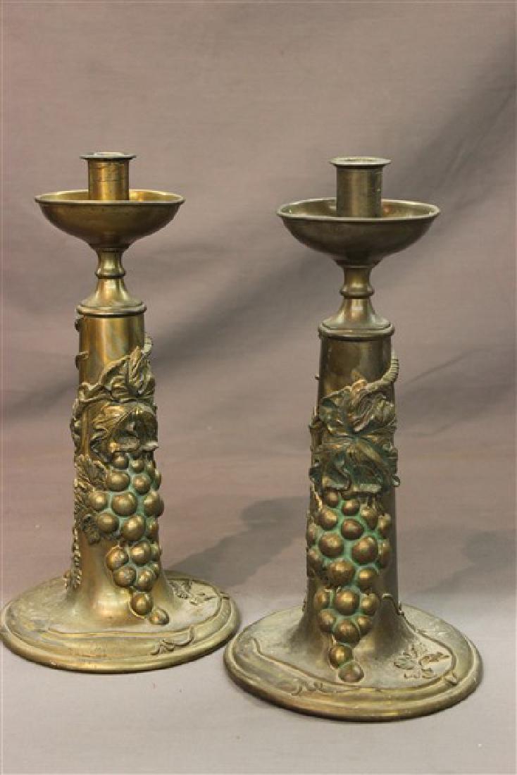 Pairpoint Candlesticks: A pair of pairpoint brass candle sticks with grape clusters and vines. Dimensions: 12 1/2" X 6"