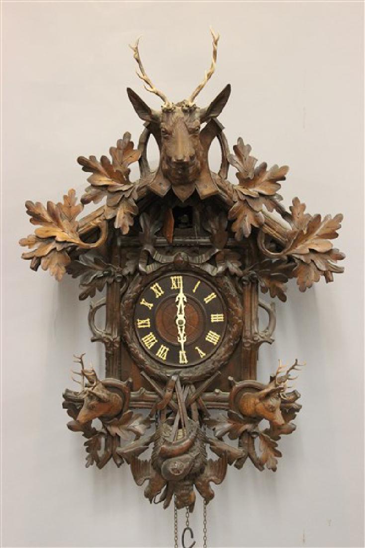Black Forest German Cuckoo Clock: A large Black Forest German cuckoo clock with hunt theme. Dimensions: 33" X 21" X 8 1/2"