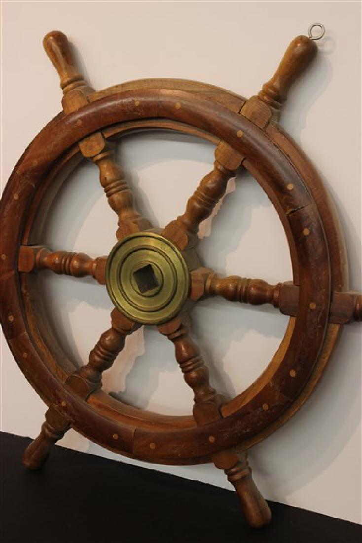 Wooden Ship Steering Wheel: A Wood and brass ship steering wheel. Dimensions: 24" Diameter