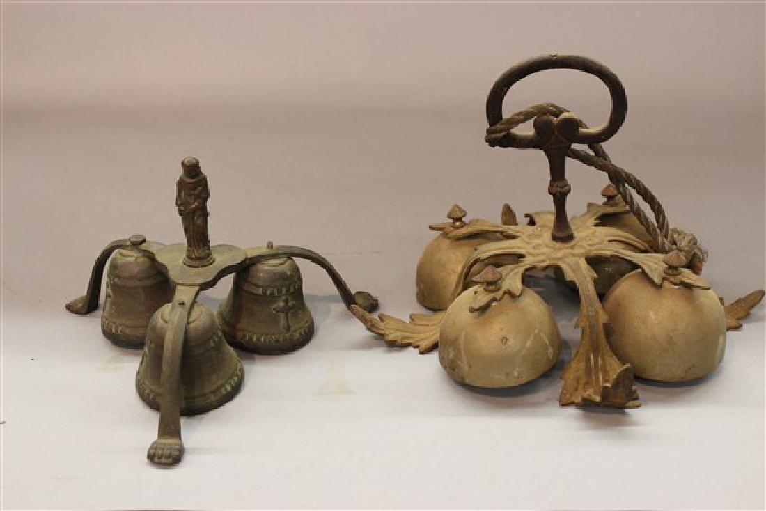 Two Antique Sacristy Communion Altar Bells: Two antique Sacristy communion altar bells. 19th century. Smaller on is bronze and dated 1713-1784 and embossed "Carmel Junipero Serra" 5 1/2" X 6 1/2" Larger One (1) is fancy brass with iron handle. 