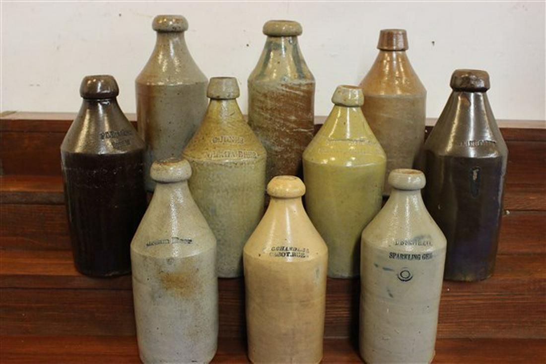 Ten (10) Stoneware Beer Bottles: Ten (10) stoneware beer bottles. G.Jones, Dream Beer, F.C. Brackett, D.B. Smith & Co. C. Chandler, Dr. J.A. Brown, RK & Co. (chipped), TH (cobalt) and some illegible. Dimensions: 9 1/2" - 10 1/2" heig