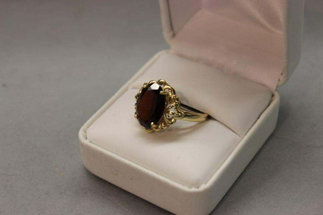 14k Gemstone Garnet Ring: A 14k yellow gold ring with mounted gemstone. Approx. 3 carat stone Size 8 t.w. 2.8 grams