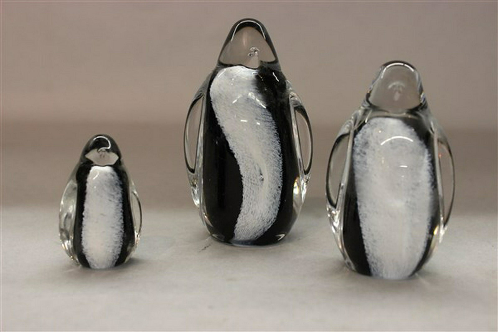 Studio Art Glass Penguin Family: A studio art glass penguin family. Dimensions: 2" - 4" heights