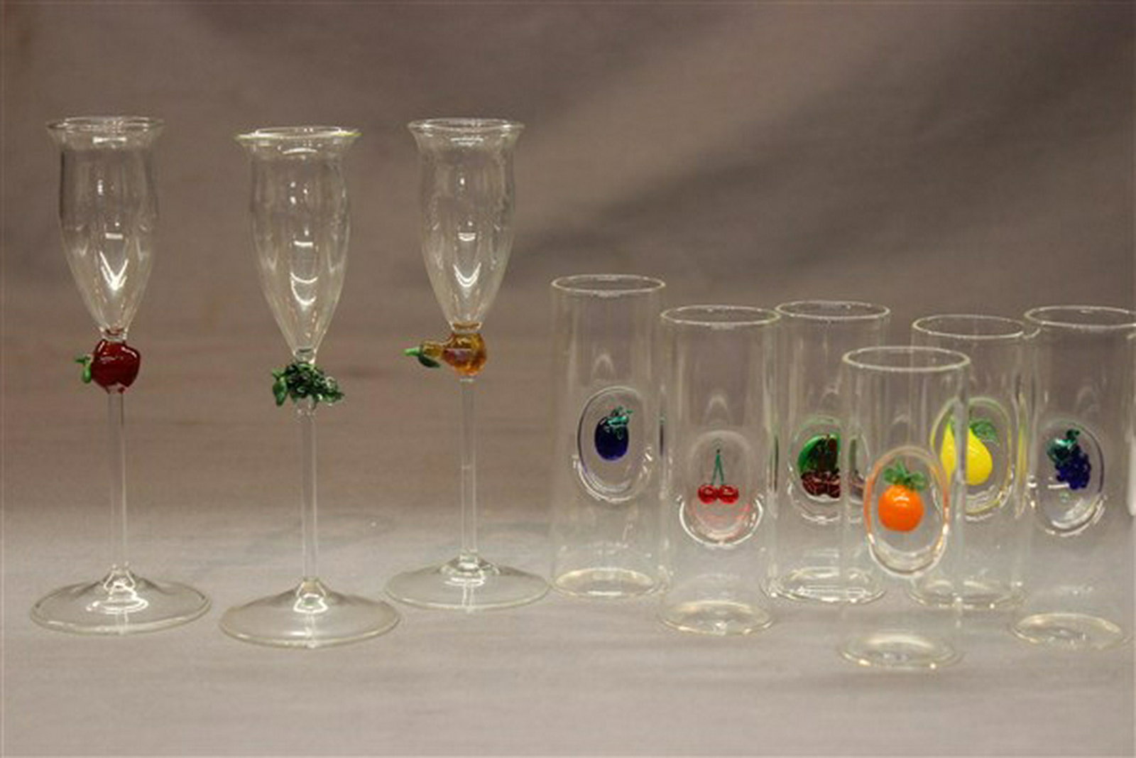 Dutch Dessert Shot Glasses: Nine (9) Dutch Dessert Shot Glasses Blown glass with applied glass fruit design Dimensions: 3" to 5 1/2" heights