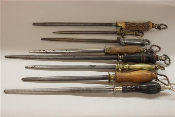 Antique Butcher Knife Sharpeners: A compiled grouping of eight (8) antique mostly English knife sharpeners with hardwood, brass and stag handles. 19th c. Dimensions: 12 1/2"L - 20" LMakers including F.Dick, Germany, Sheffield, Sterlin