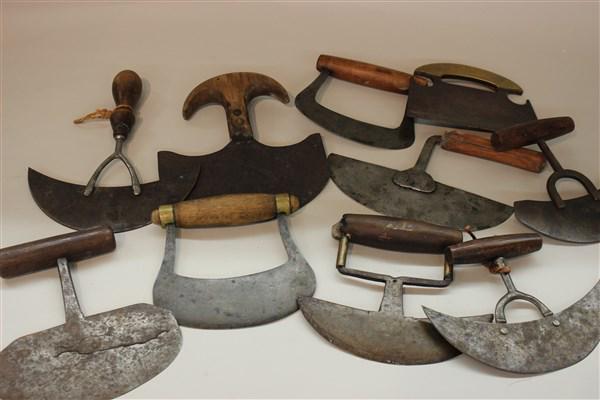 Thirteen Antique Food Herb Choppers: A group of antique food choppers. Steel blades with wood handles. Thirteen in total.