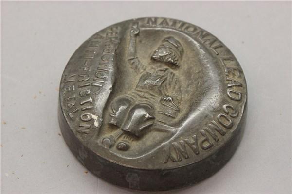 1907 Lead Dutch Boy Paint Advertising Ingot: A round block of lead. c.1907 Dutch Boy paint advertising. Dimensions: 3 1/2" d.