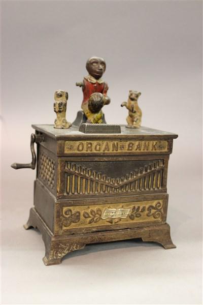 Mechanical Organ Bank w/ Monkey: A antique 19th century cast iron mechanical Organ Bank. c.1882. Dimensions: 7 1/2" X 5" X 4"