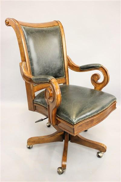 Executive Carved Hardwood Desk Chair: A fine executive carved hardwood and leather desk chair. Made by Hooker furniture companyDimensions: 42"h X 23"L X 30"d
