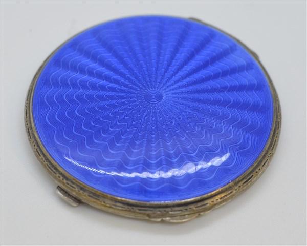 Sterling Silver Enameled Compact: A sterling silver blue enameled compact. Dimensions: 2 1/2"d Total weight: 2.2 avg. oz.