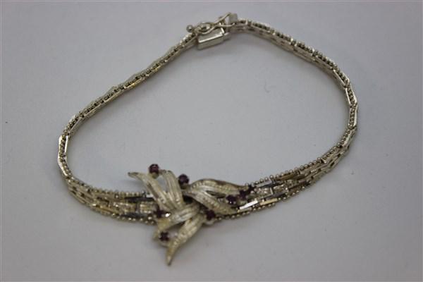 Italian Sterling Silver Ruby Bracelet: An Italian sterling silver bracelet with rubies. 925 Italy. Dimensions: 8" length t.w.: .5 avg. oz.