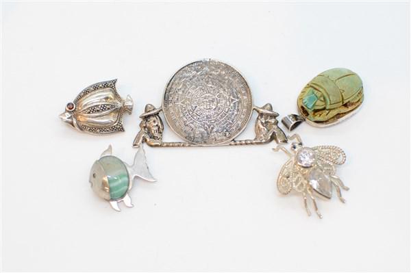 Mexican Sterling Silver Vintage Pin Lot: A compiled grouping of estate sterling silver pins including Mexican, marcasite, Scarab etc. As seen in photograph preview. Total weight: 1.09 troy ounces