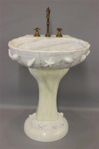Carved Sea Shell Marble Pedestal Sink, NEW: A high quality unused marble sink with carved sea life and pedestal base to match. Sink will wall mount optional without base. Dimensions: 44" h overall including faucets 35" without. 24"width and 18