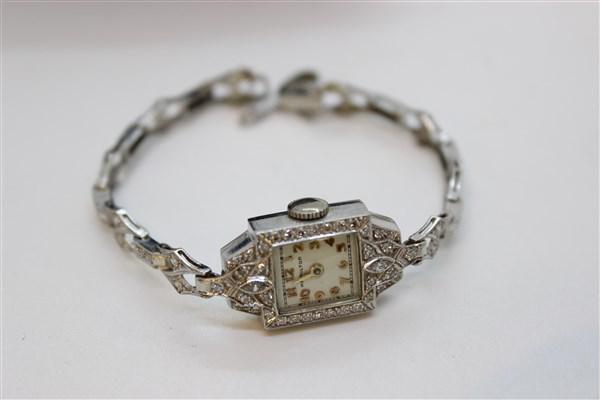 Hamilton Diamond And Platinum Watch: A Hamilton diamond and platinum watch. Platinum face and band with mine cut brilliant diamonds. Dimensions: 6" length Total weight:17.3 grams