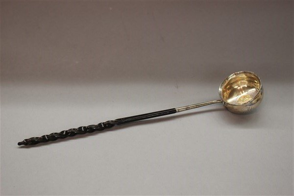 Sterling Silver Wine Tasting , English King George II: An antique sterling silver wine tasting cup with ebonized wood twisted handle. Inset Georgivs II coin. Monogramed ML in cursive.Dimensions: 12" X 2"d