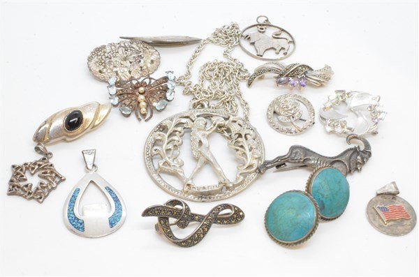 Vintage Sterling Silver Jewelry Lot: A compiled grouping of sterling silver jewelry. Mostly vintage pieces including pins, pendants, charms, necklaces with marcasite, turquoise, onyx etc. As seen in photograph preview.Total weight: 4.43 
