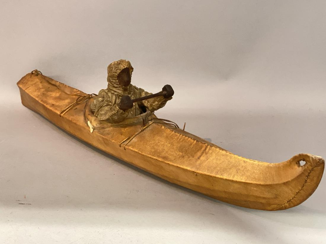 Vintage Alaskan Inuit Carved Wood And Hide Canoe: Vintage Alaskan Inuit carved wood figure in a hide covered canoe. Dimensions: 5 1/2"h X 26 1/2"LCondition Report: Some loss to covered over head. Please see photograph preview or call.