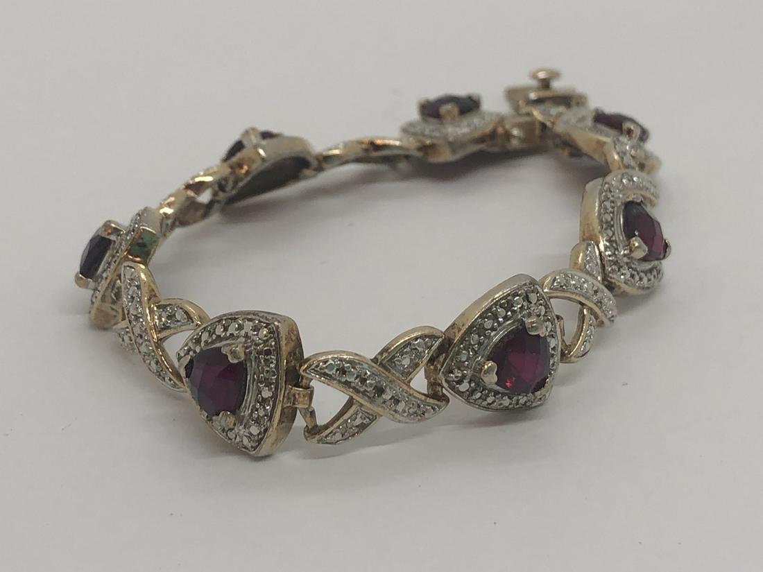 Sterling Silver Garnet And Marcasite Bracelet: A sterling silver garnet and marcasite bracelet. 7" length.