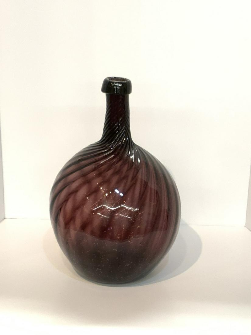 Vintage Amethyst Bottle: Vintage amethyst twisted long neck bottle. Hand blown with broken pontil mark at base. Dimensions: 15" X 10 1/2"