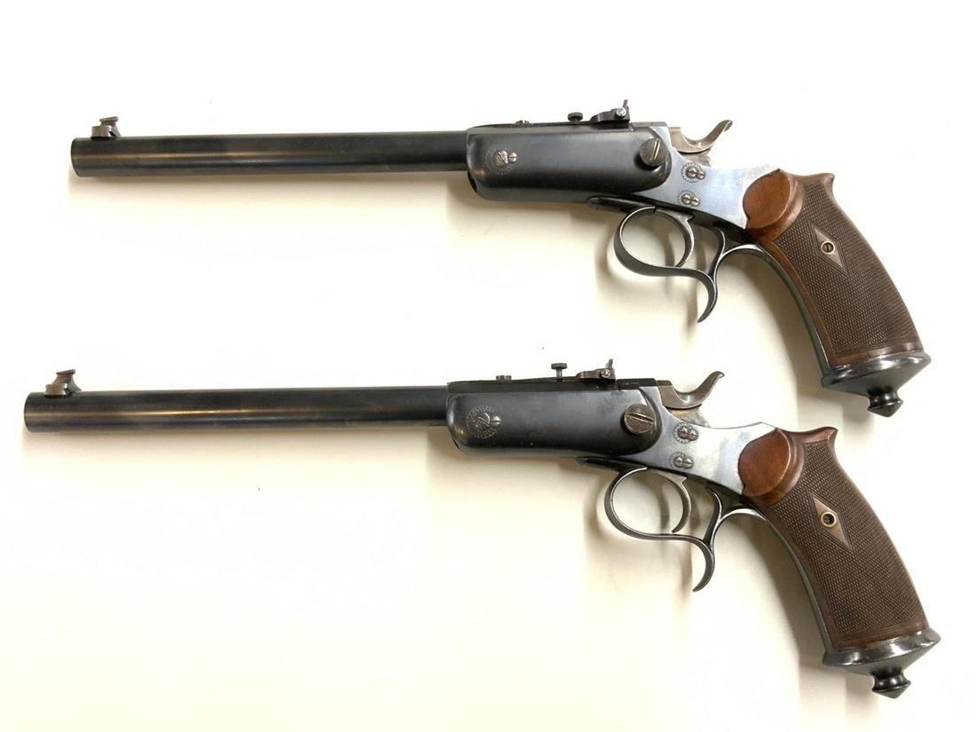 A Pair, Le Chobert French Target Pistols 44 Russian: Early 20th c.. 44 cal Russian target pistols made for Le Chobert, 16r Lafayette, Paris. Serial numbers 1663 and 1664 with Belgium maker touch marks. Checkered stock. Pristine condition. Attributed to 