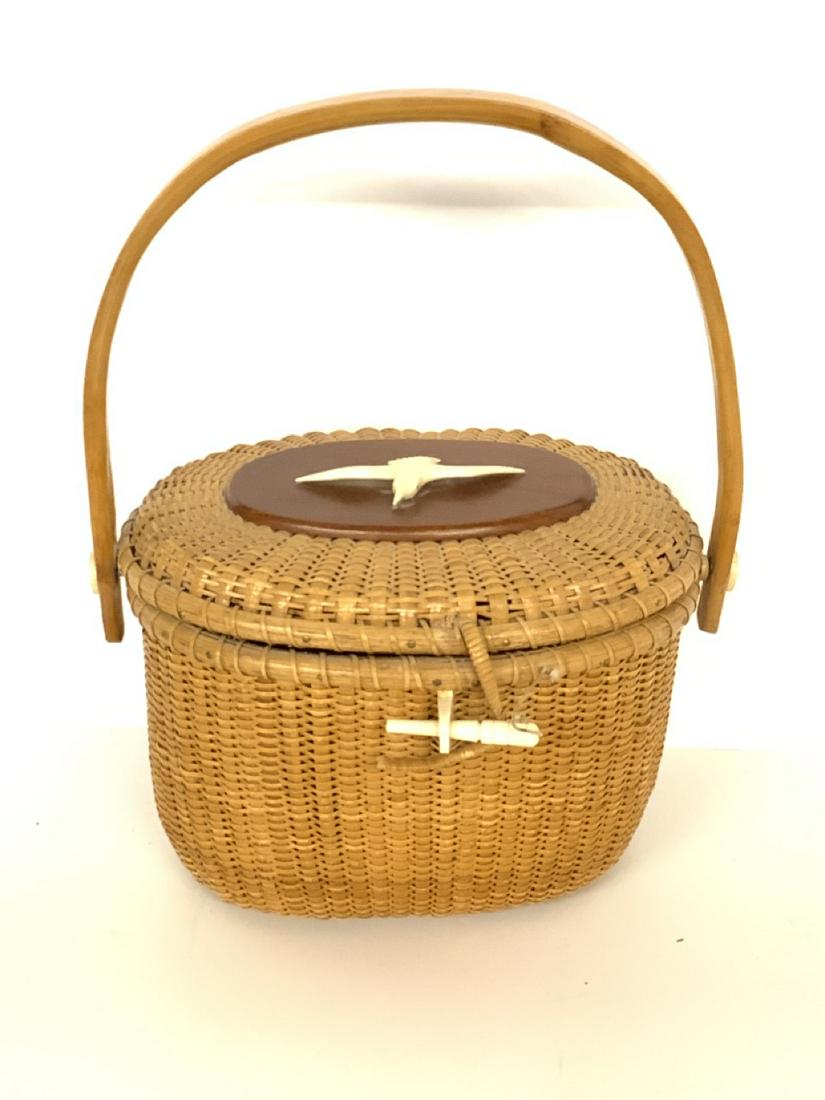 Vintage Nantucket Basket: A vintage Nantucket basket with carved nautical themed whale bone. A quality region basket, not signed. Dimensions: 12" X 10" X 7 1/2" Latch has unraveled small minor repair needed.