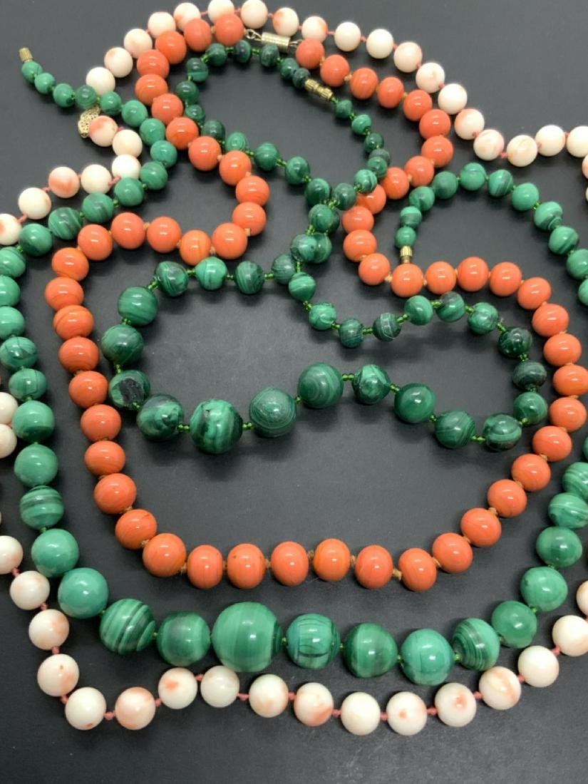 Estate Lot Of Coral And Malachite Necklaces: Four (4) assorted coral and malachite stone necklaces. Dimensions: 18"-29" lengths