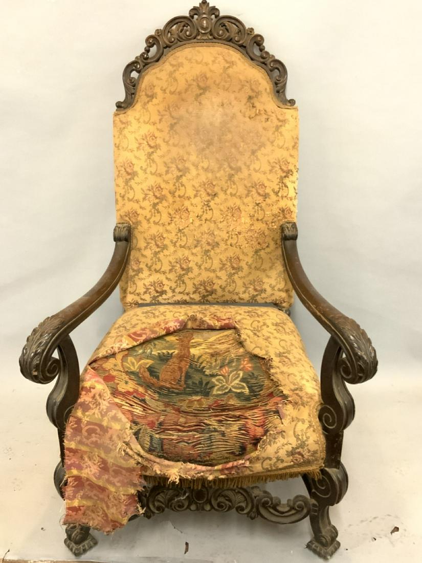 Carved Mahogany Oversized Tapestry Arm Chair: Large oversized carved mahogany arm chair. Older frayed tapestry seated seen under soiled upholstery. Full restoration needed. Frame is sturdy and sound.Dimensions: 55"h X 29"w X 29"d