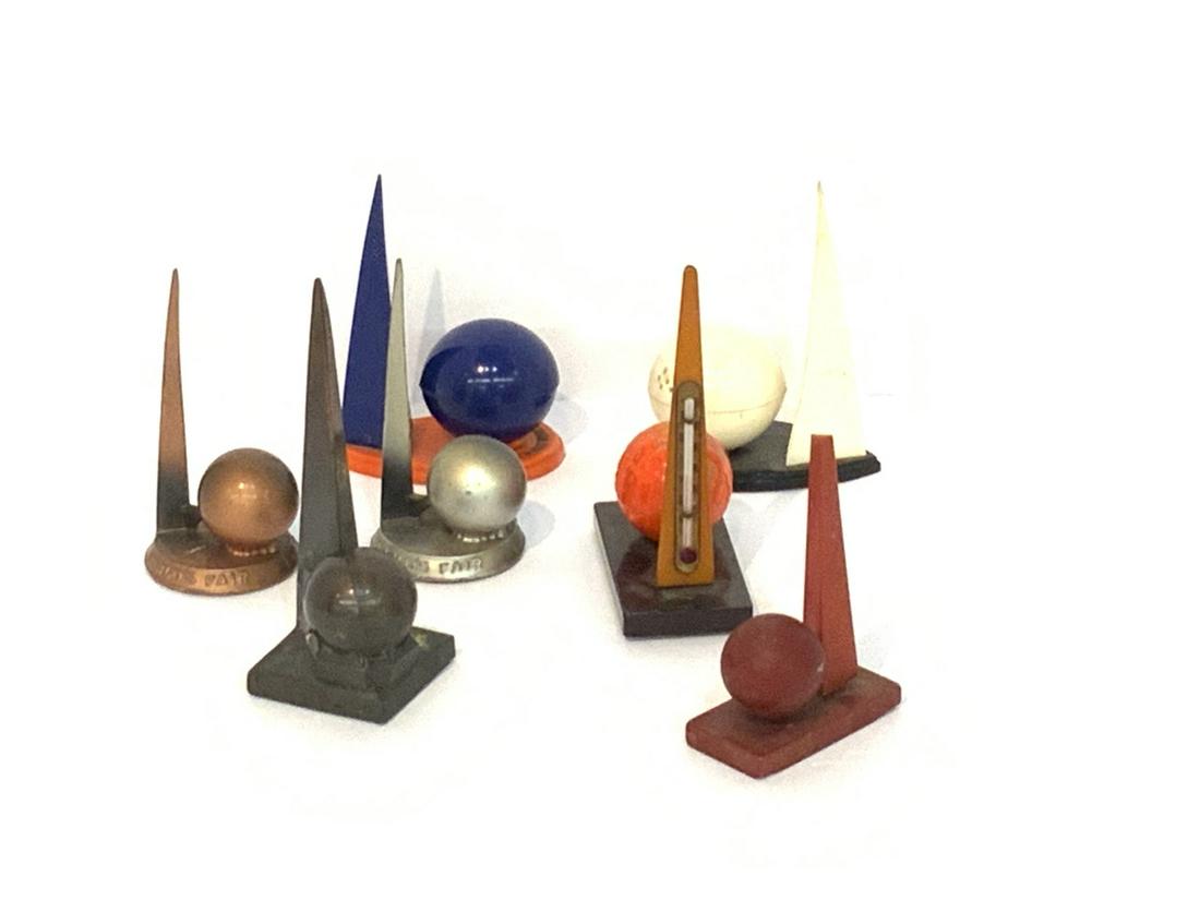 1939 New York World's Fair Trylon And Perisphere Sets: Seven (7) 1939 New York World's Fair Trylon and Perisphere sets. Bakelite, metal and plastic material. Dimensions: 3 1/2"-4"h